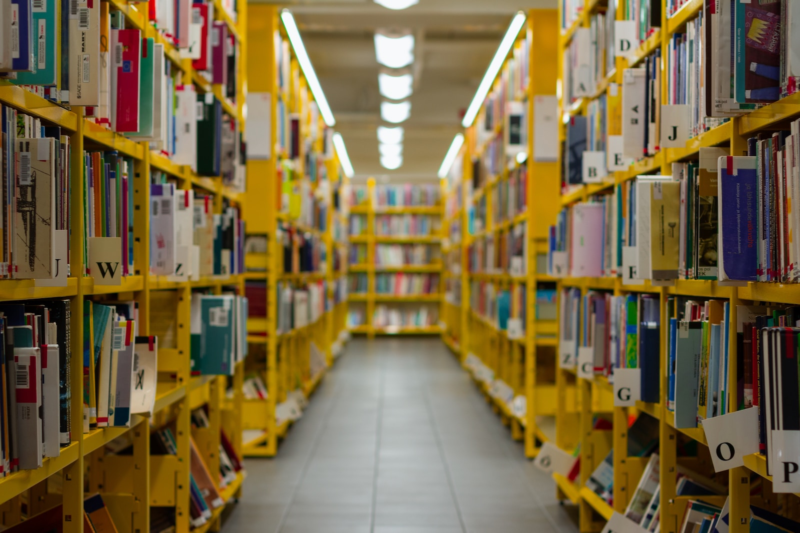 a long row of yellow shelves filled with books